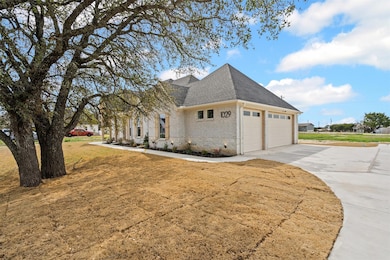View of property exterior with a lawn, driveway, r