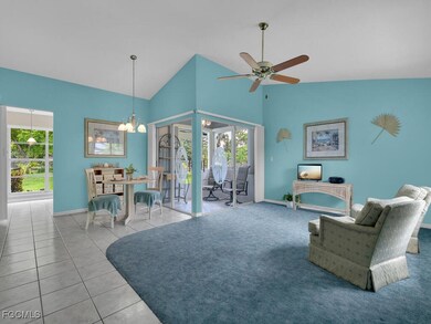 Living room featuring a chandelier, a ceiling fan,