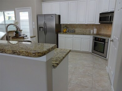 View to outdoor Atrium and refrigerator that is included!