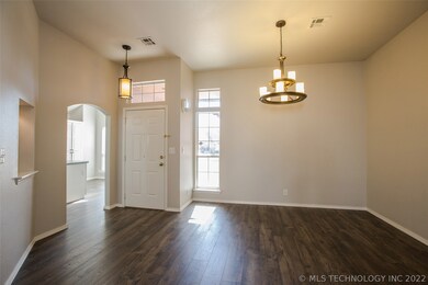 Formal Dining opens to Entryway with updated light