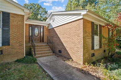 Newly stained front door. Pyracantha to the right.