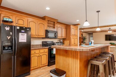 Kitchen with light hardwood / wood-style floors, b