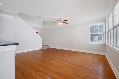 Unfurnished living room featuring crown molding, 