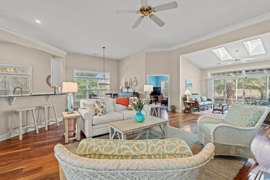 Living room featuring ceiling fan with notable cha