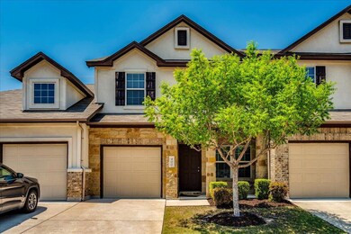 View of property with stone siding, stucco siding