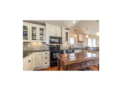 Kitchen with granite counters, unique backsplash, 