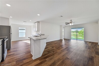 Kitchen with white cabinetry, a wealth of natural