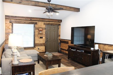 Living area with wood finished floors, a wainscote