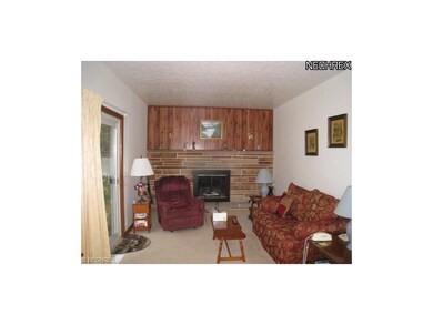 Nice family room with wood burning fireplace.