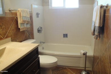 HALL BATH TILED WITH TUB