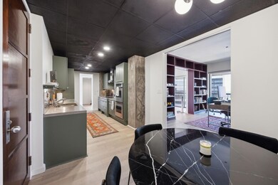 Kitchen with concrete countertops, light wood fini