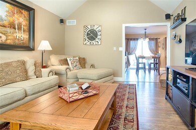 Living room with wood floors and cathedral ceiling