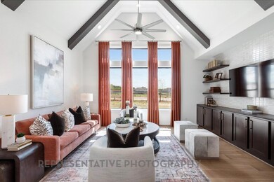Living area featuring beamed ceiling, a ceiling f