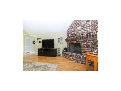 Family Room - brick rounded fireplace