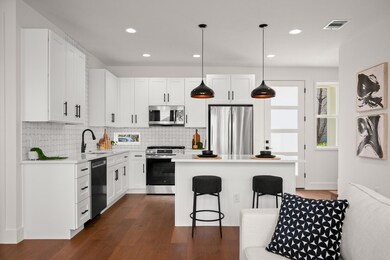 Kitchen with a breakfast bar, a sink, visible ven