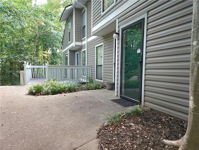 Property entrance featuring a patio and a wooden deck