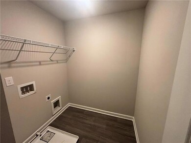 Laundry area featuring washer hookup, dark hardwoo