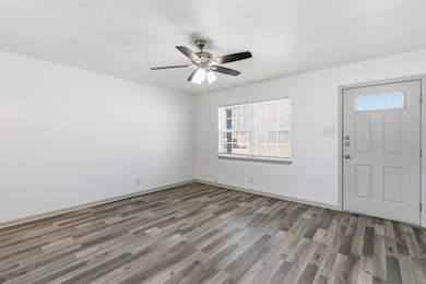 Foyer entrance featuring wood finished floors and a ceiling fan