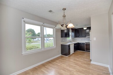 Kitchen featuring decorative backsplash, light har