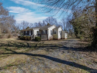 View of front of property with a front yard and dr