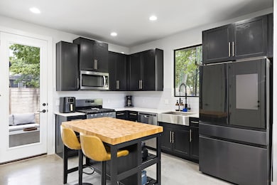 Kitchen featuring stainless steel appliances, a s