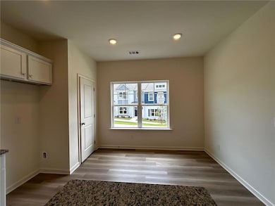 Unfurnished dining area with light wood-type flooring and recessed lighting