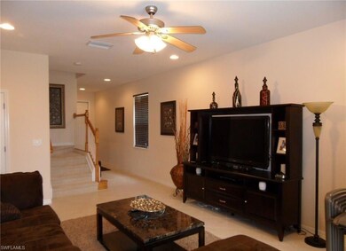 Living area with visible vents, recessed lighting,