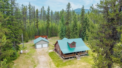 View from above of property featuring a heavily wooded area and mountains