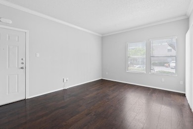 Empty room with baseboards, dark wood-style floor