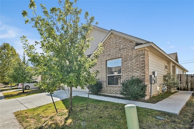 View of home's exterior with brick siding and driveway