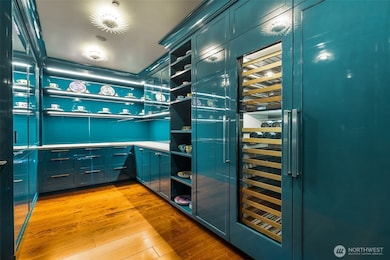 Larger group? Butler's pantry is here to serve, with discreet access from the 2nd elevator vestibule through the laundry area (2 sets of wifi-enabled washers/dryers, utility sink, etc.). Surrounded by ultra-high-gloss lacquer, the shelving is great for displaying your finest. Sub-Zero refrigerator, freezer and wine storage. Honed Azul Adobe limestone countertops; plumbed for espresso maker. Fun light fixtures.