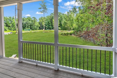 Wooden deck featuring a yard and view of scattered trees