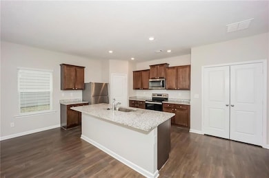 Kitchen with stainless steel appliances, a sink, d