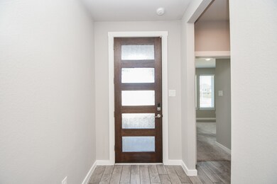 This is your cool entrance from inside the main entry; with peaceful neutral walls, and rustic inspired wood-look tile (?) floors. Natural light comes from the door panels and walls of windows in the front room, right. Inside, are 4 bedrooms, 3-1/2 baths, all comprising a generous 11,356 square-foot-lot with 2,642 square-feet of interior living space.
