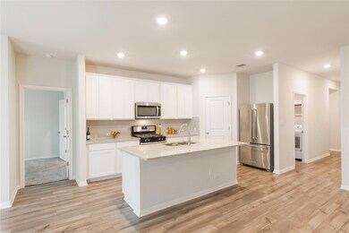 Kitchen with appliances with stainless steel fini