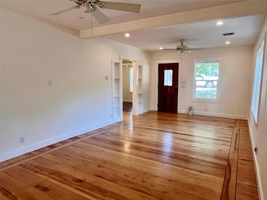Unfurnished living room with light wood-style flo
