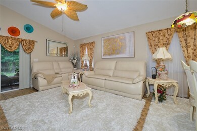 Living room with ceiling fan and vaulted ceiling