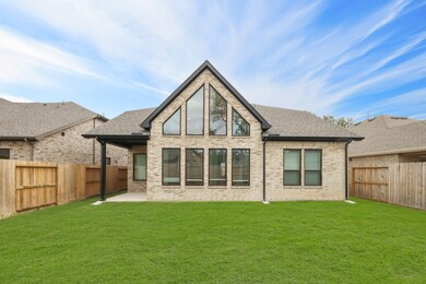 Large backyard with back patio, full brick on the rear of the home.