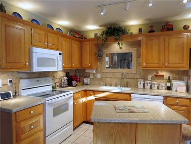 Cooks kitchen with solid surface countertops and indirect lighting.