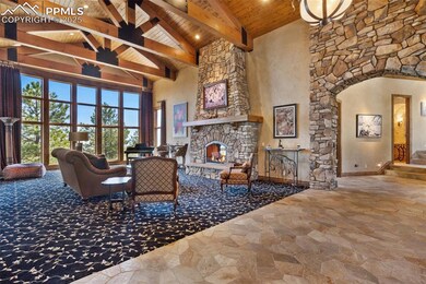 Living room with exposed structural beams, stone w