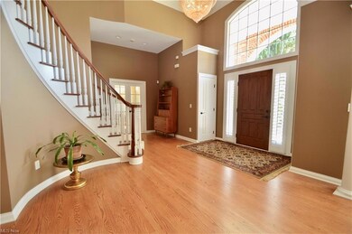 Grand foyer with soaring ceiling and open curved s