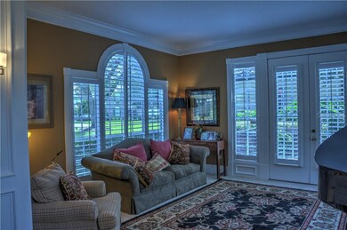 Formal Living Room with French doors, plantation shutters, beautiful architrave.