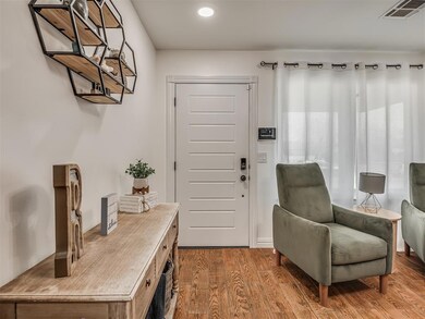 Foyer featuring wood finished floors and visible v
