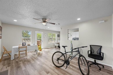 Living Room with Ceiling Fan and Wood Burning Fireplace