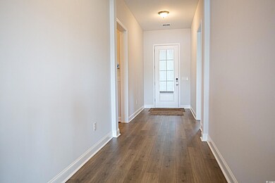 Doorway with dark hardwood / wood-style floors
