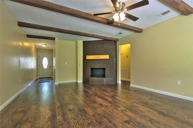 Living Room with wood burning Fireplace.  Foyer in