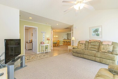 Carpeted living room featuring vaulted ceiling, or