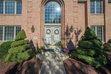 The elegant front entry has a quoined surround, an