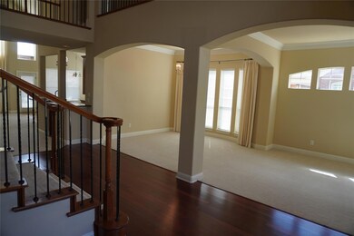 Entrance foyer featuring wood-type flooring and crown molding