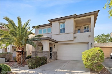 View of front of home with driveway, stone siding,